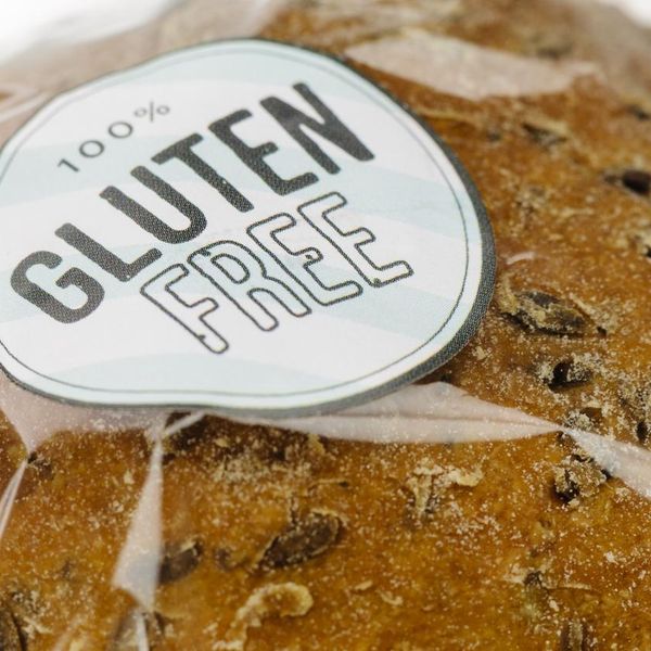 "100% Gluten Free" sticker on a loaf of brown seeded bread