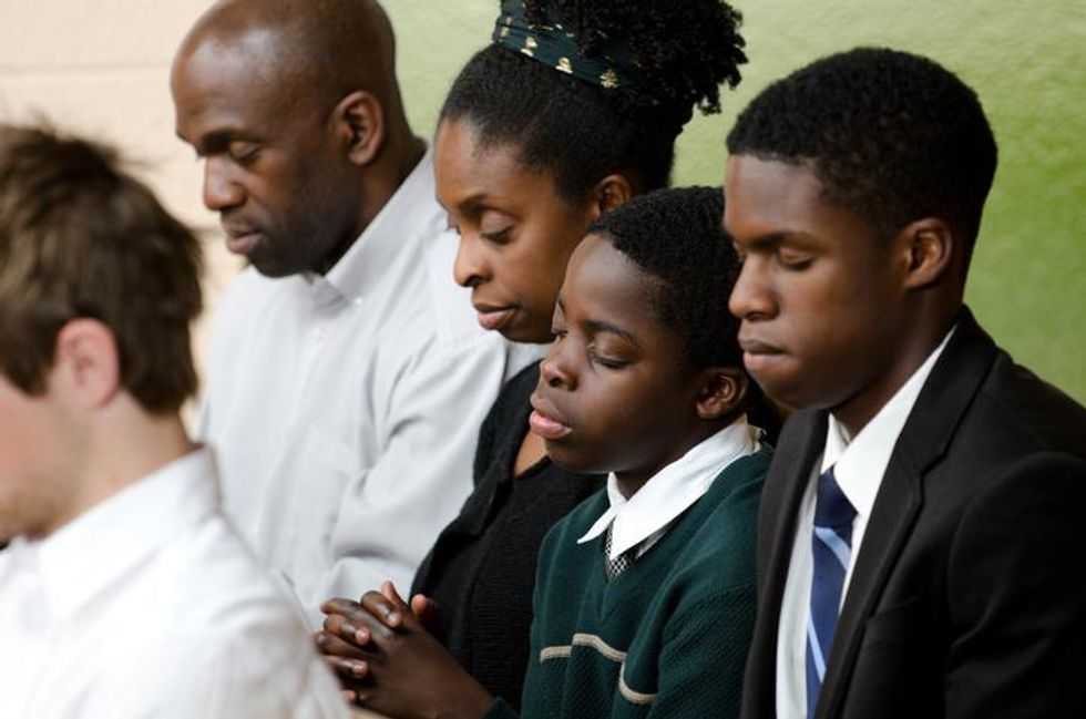 A family praying in church