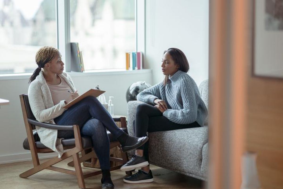 A Therapist meets with her female client in her office.