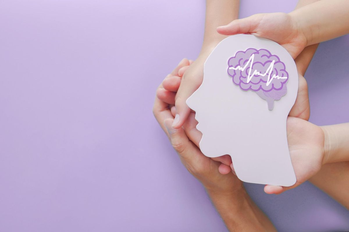 Adult and child hands holding encephalography brain