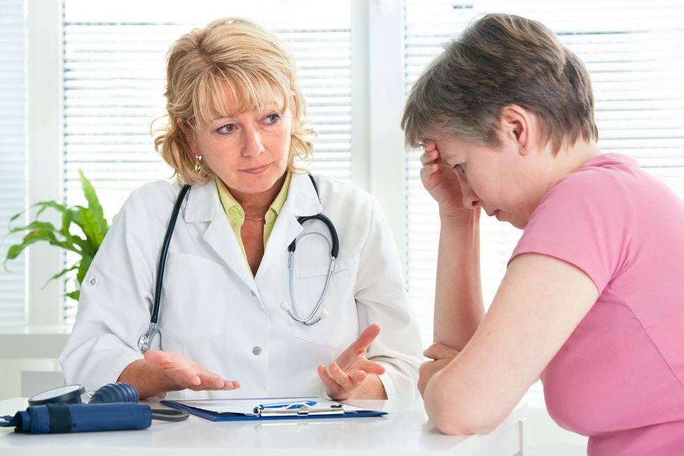 adult woman talking to doctor about her diagnosis