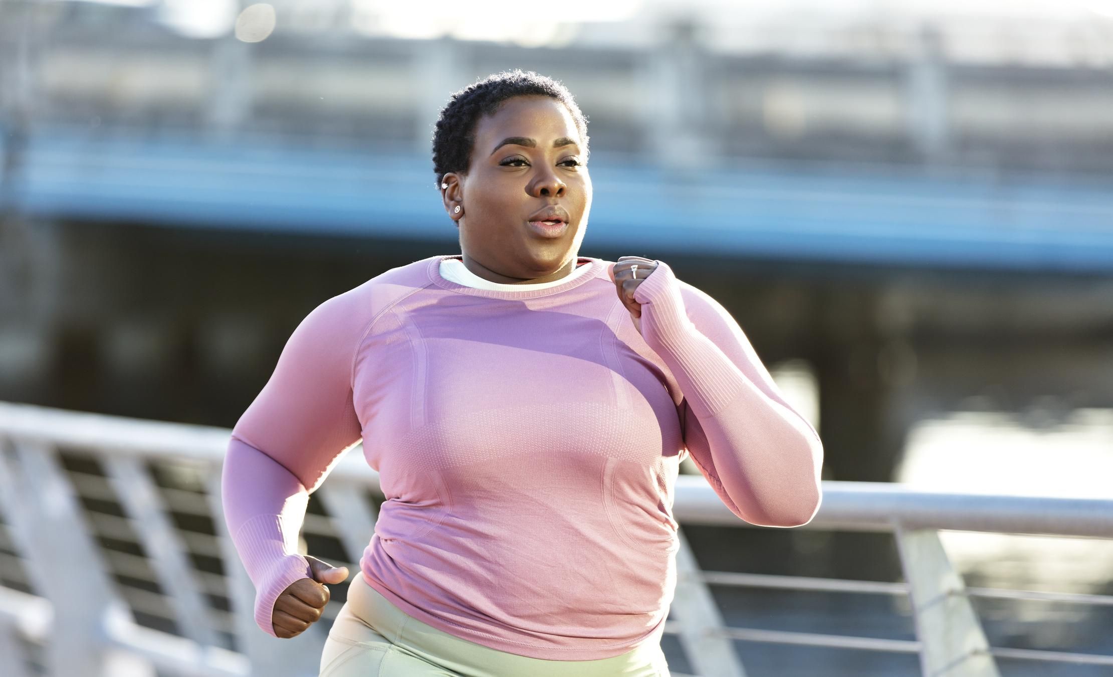 African-American woman with large build, running in city