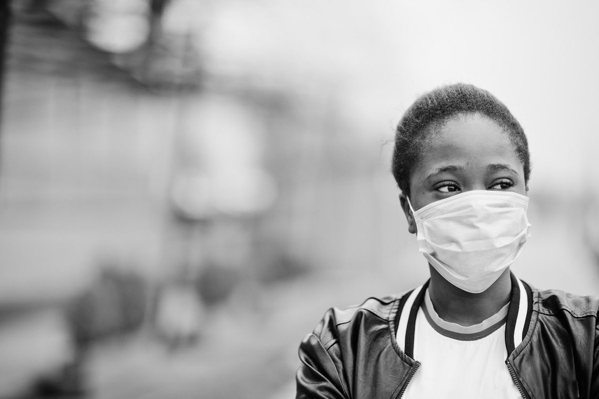 African girl at park wearing medical mask