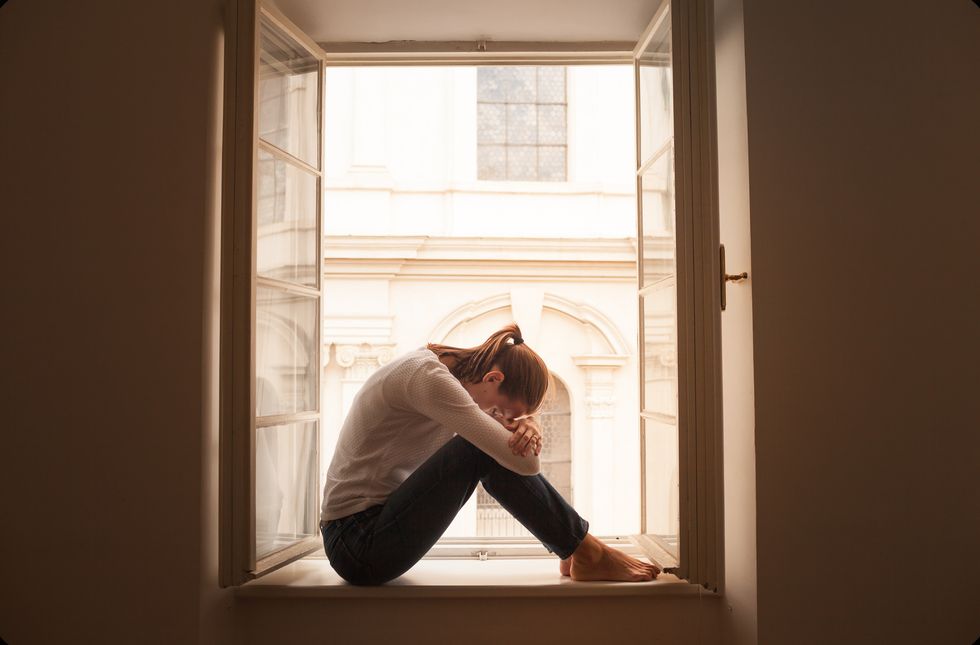 Alone and sad female in her city apartment.
