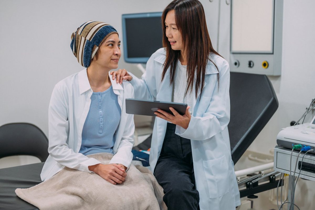 Asian female gynecologist talking to her patient about cervical cancer clinical trials
