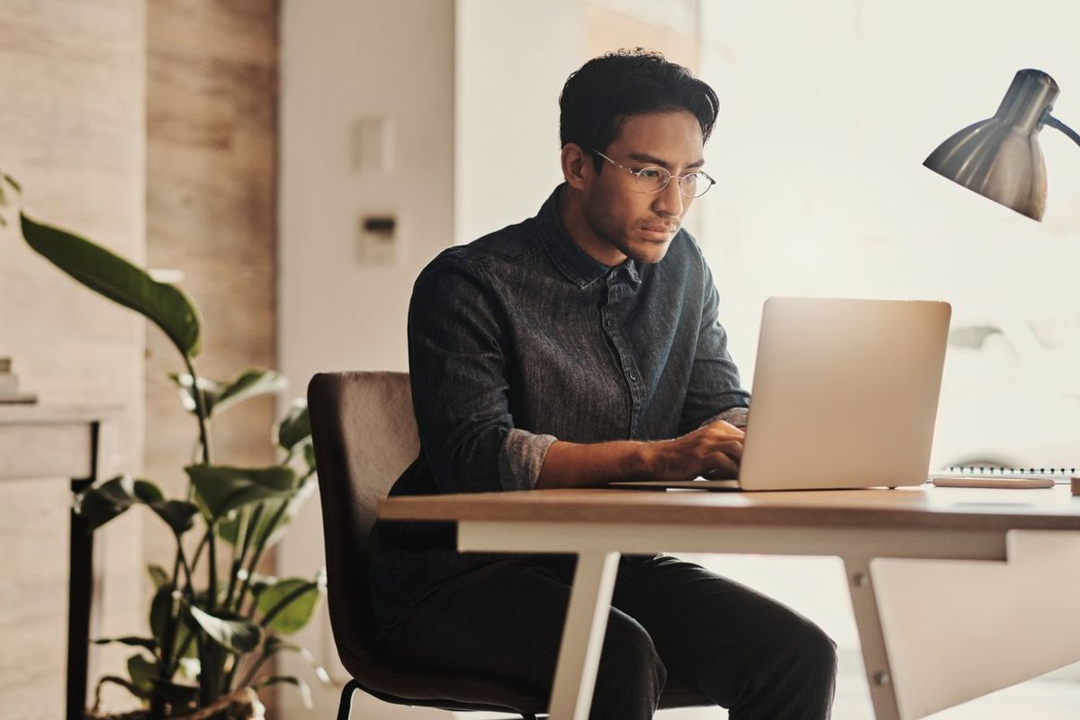 asian man working on his computer