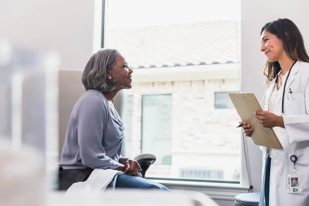 Attentive doctor listens to senior patient