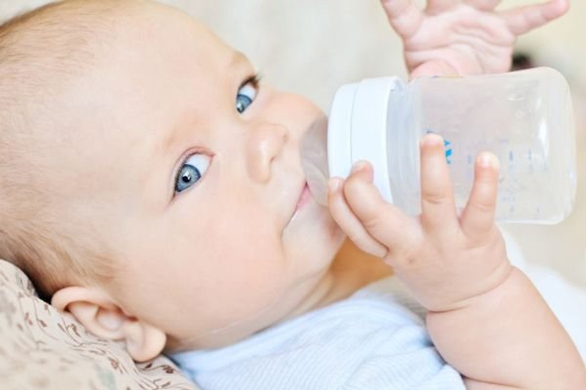 baby drinking milk from a bottle