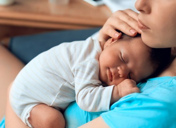 baby girl sleeping on her mother's chest