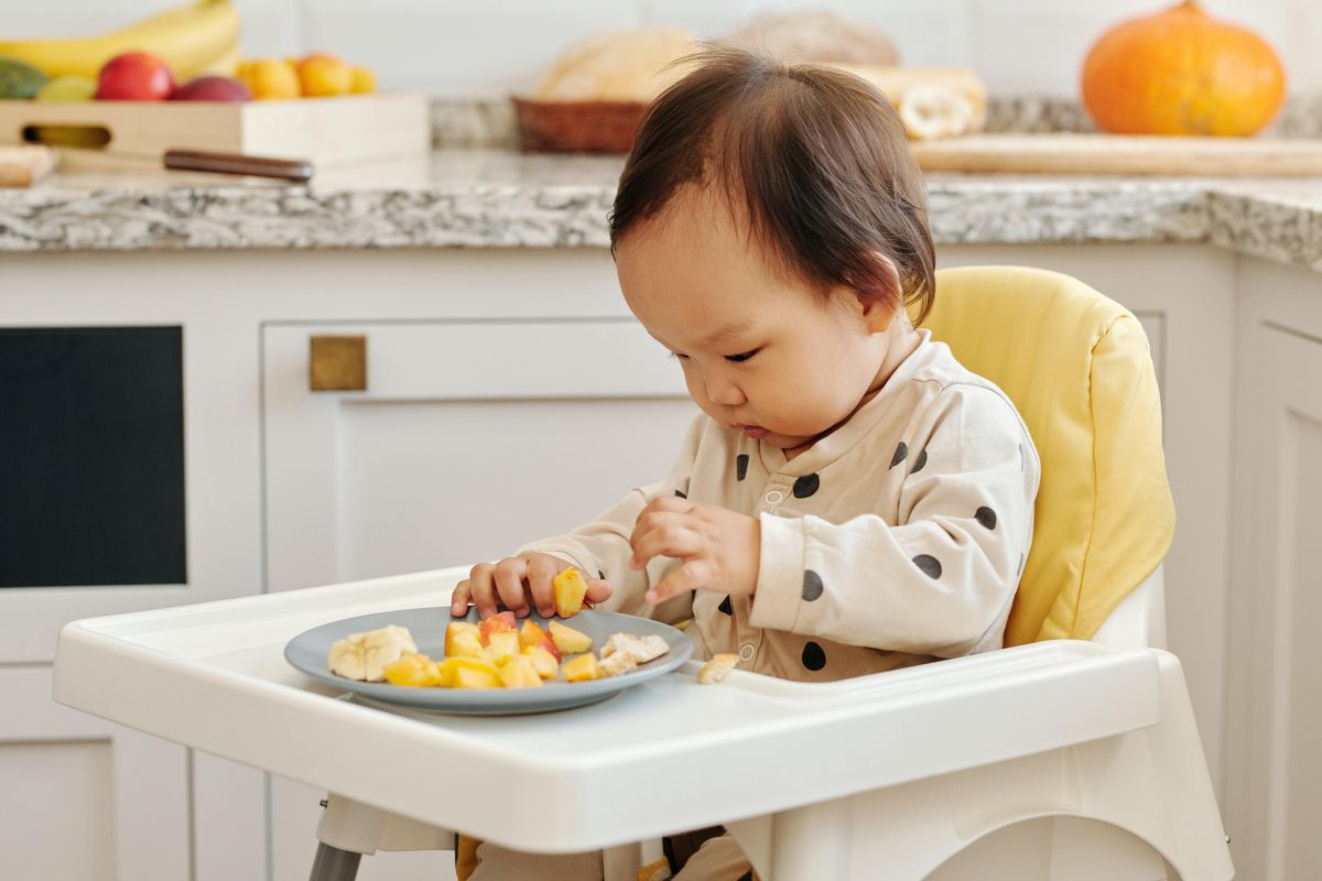 baby in high chair eating