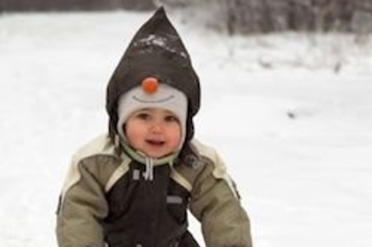 baby playing in the snow