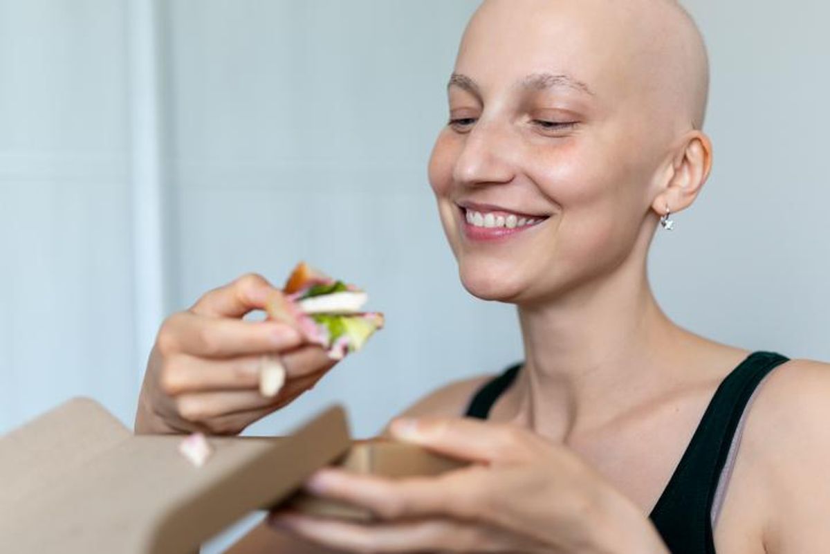 bald shaved hair woman portrait enjoy eating sandwich for lunch