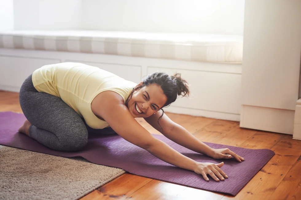 beautiful young woman practicing yoga to Strengthen her Pelvic Floor at home