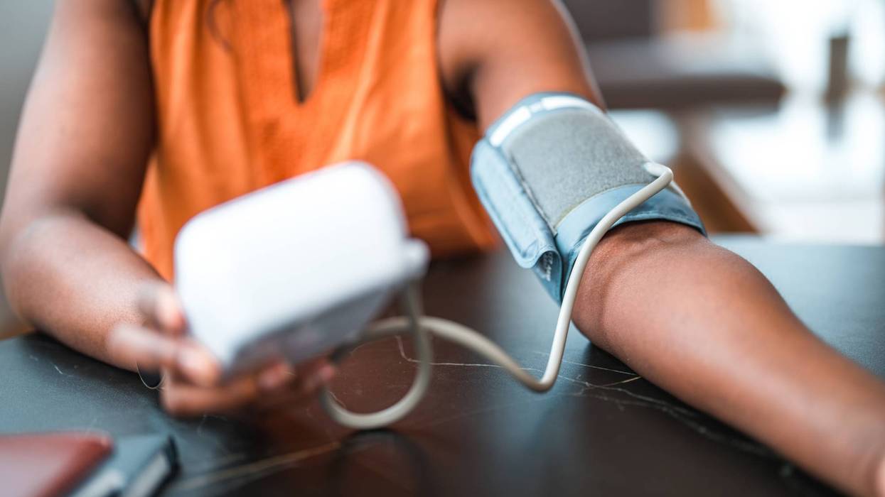 Black Female Using A Medical Device For Blood Pressure Measuring