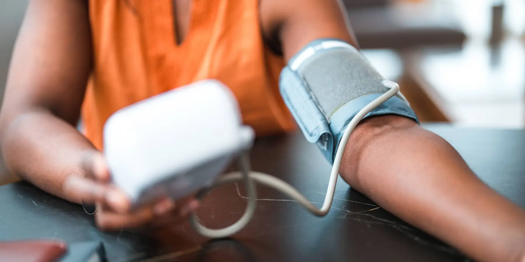 Black Female Using A Medical Device For Blood Pressure Measuring
