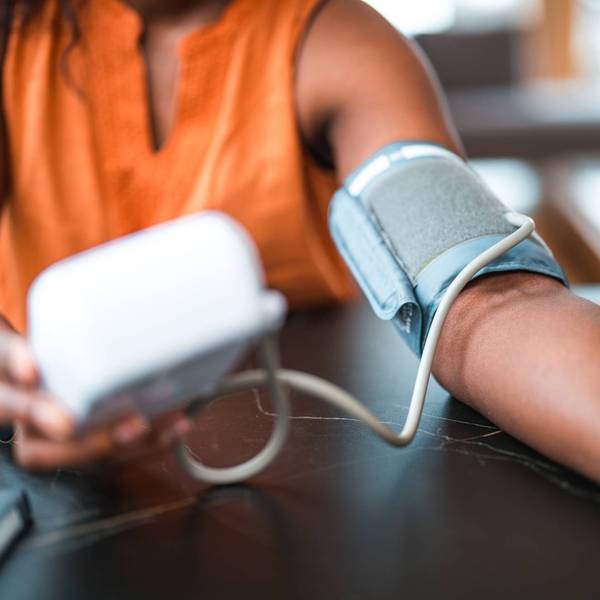 Black Female Using A Medical Device For Blood Pressure Measuring