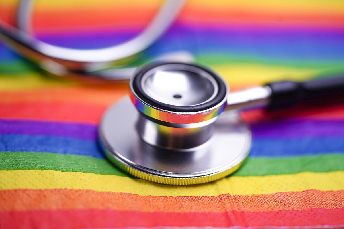 Black stethoscope on LGBT flag background