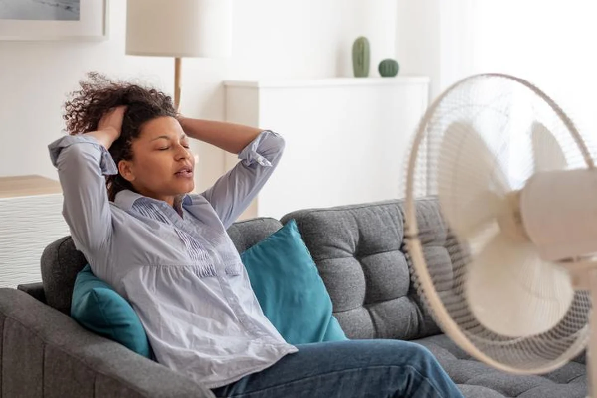 Black woman at home refreshing during summer haze