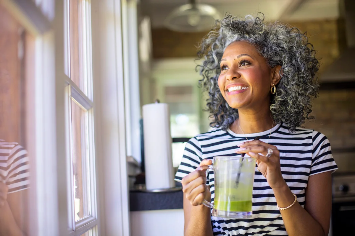 Black Woman Drinking a Green Smoothie