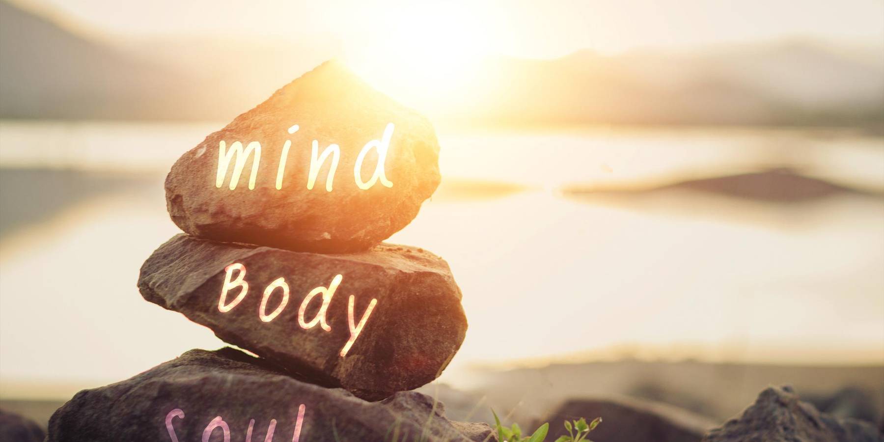 Body, mind, soul, spirit written on rocks