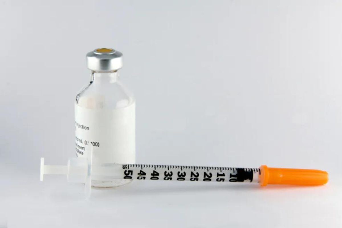 bottle of insulin and needle