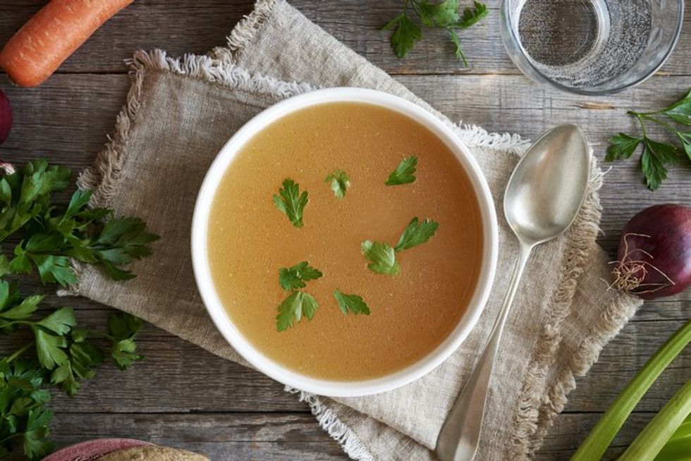 bowl of chicken bone broth on a table
