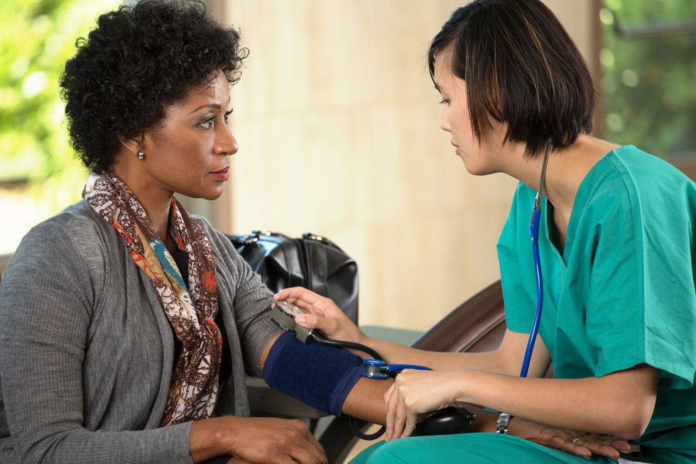 burse checking patient's blood pressure