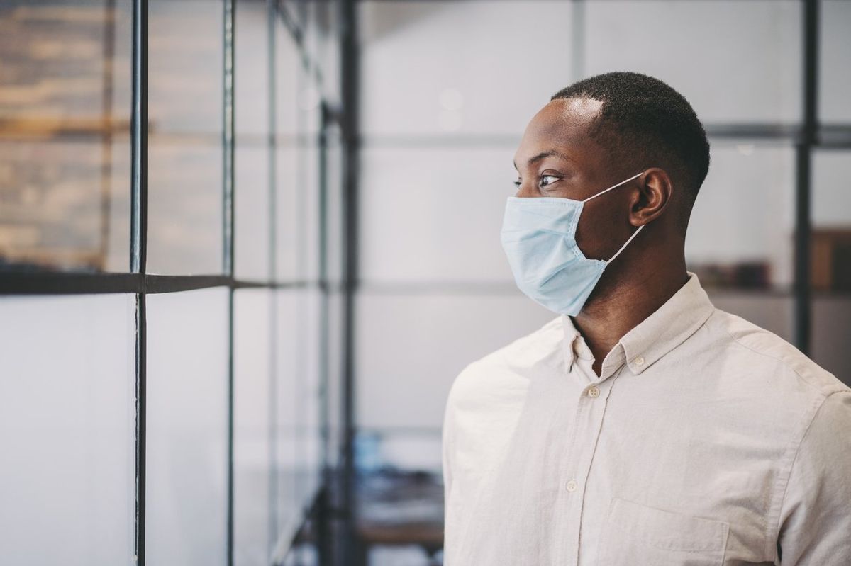 Businessman with protective face mask at work