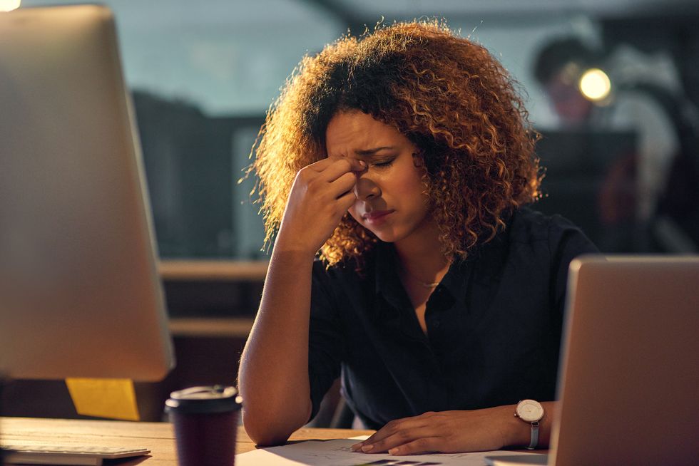 businesswoman experiencing stress during a late night at work