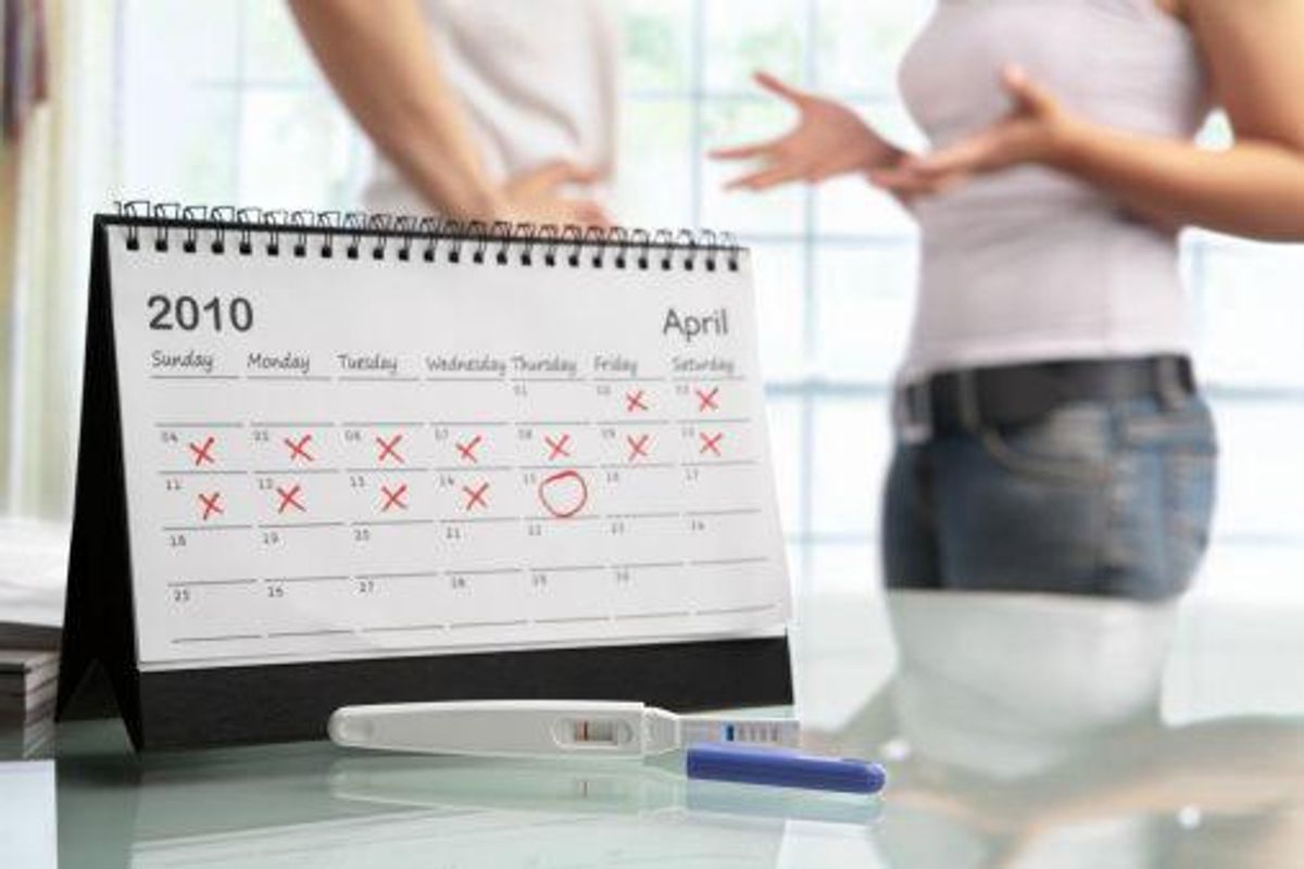 calendar next to a pregnancy test