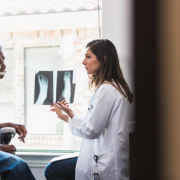 Caring doctor discusses patient's x-ray