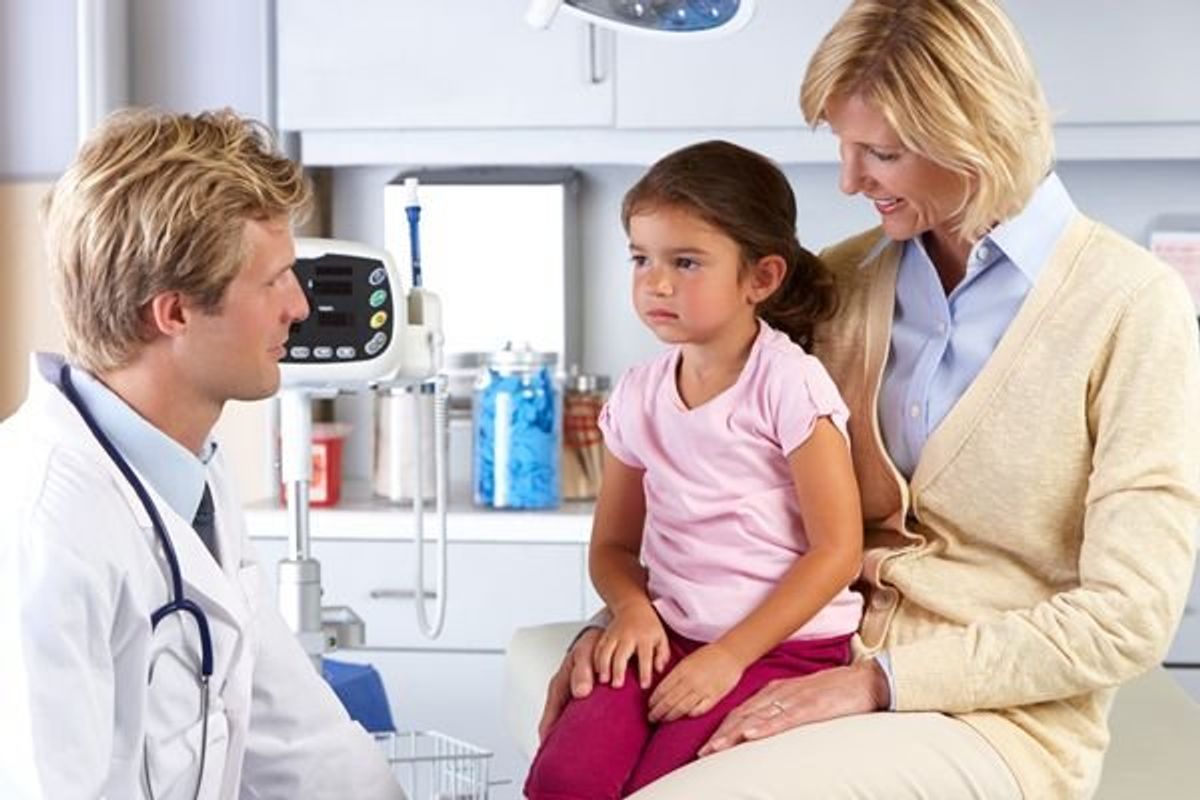 child and parent in consultation with the doctor