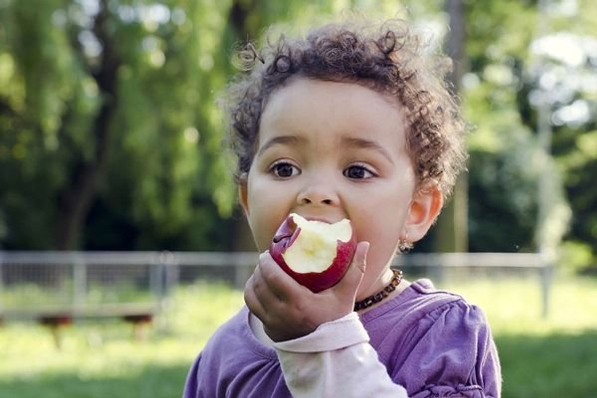child eating an apple