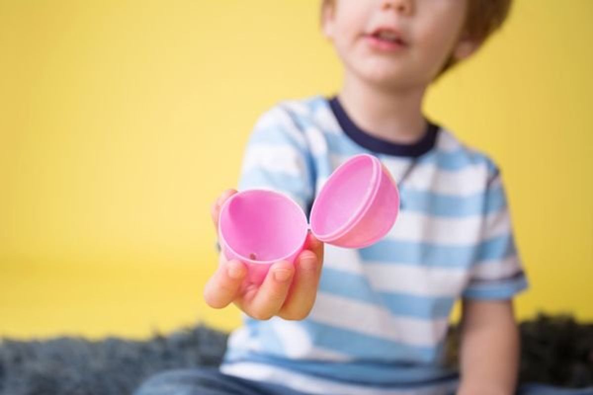 child holding empty easter egg