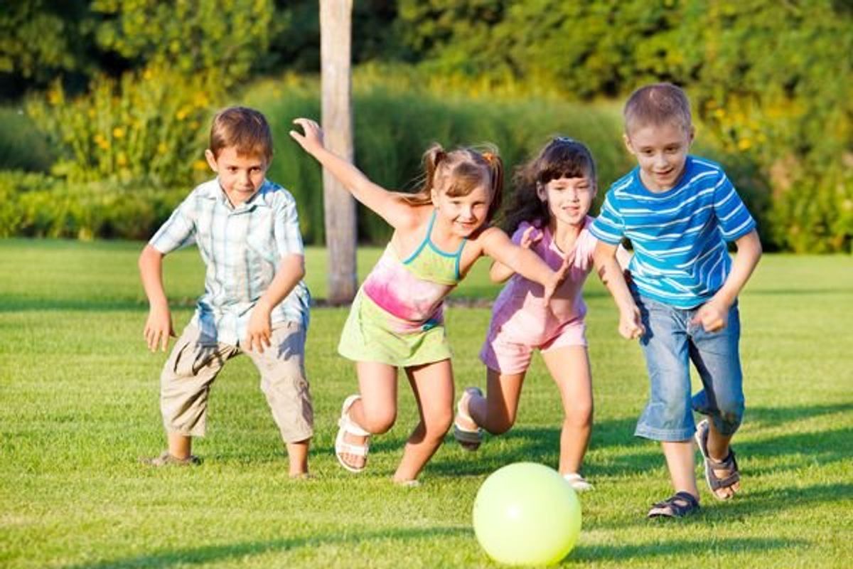 children chasing a ball