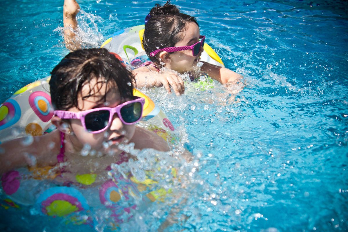 children swimming in a pool