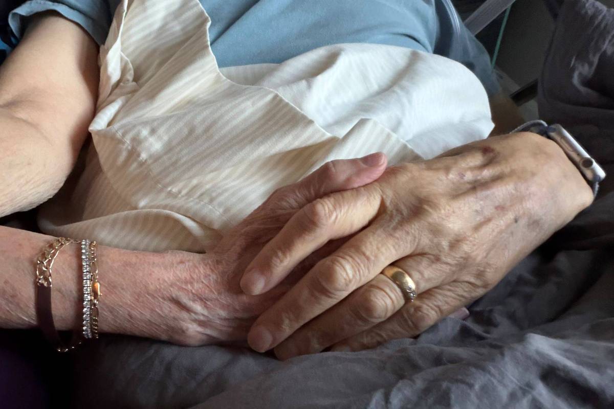 christine and her partner holding hands