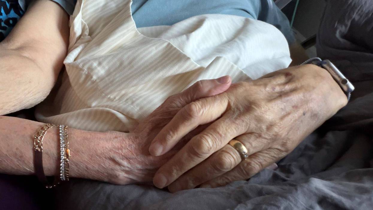christine and her partner holding hands