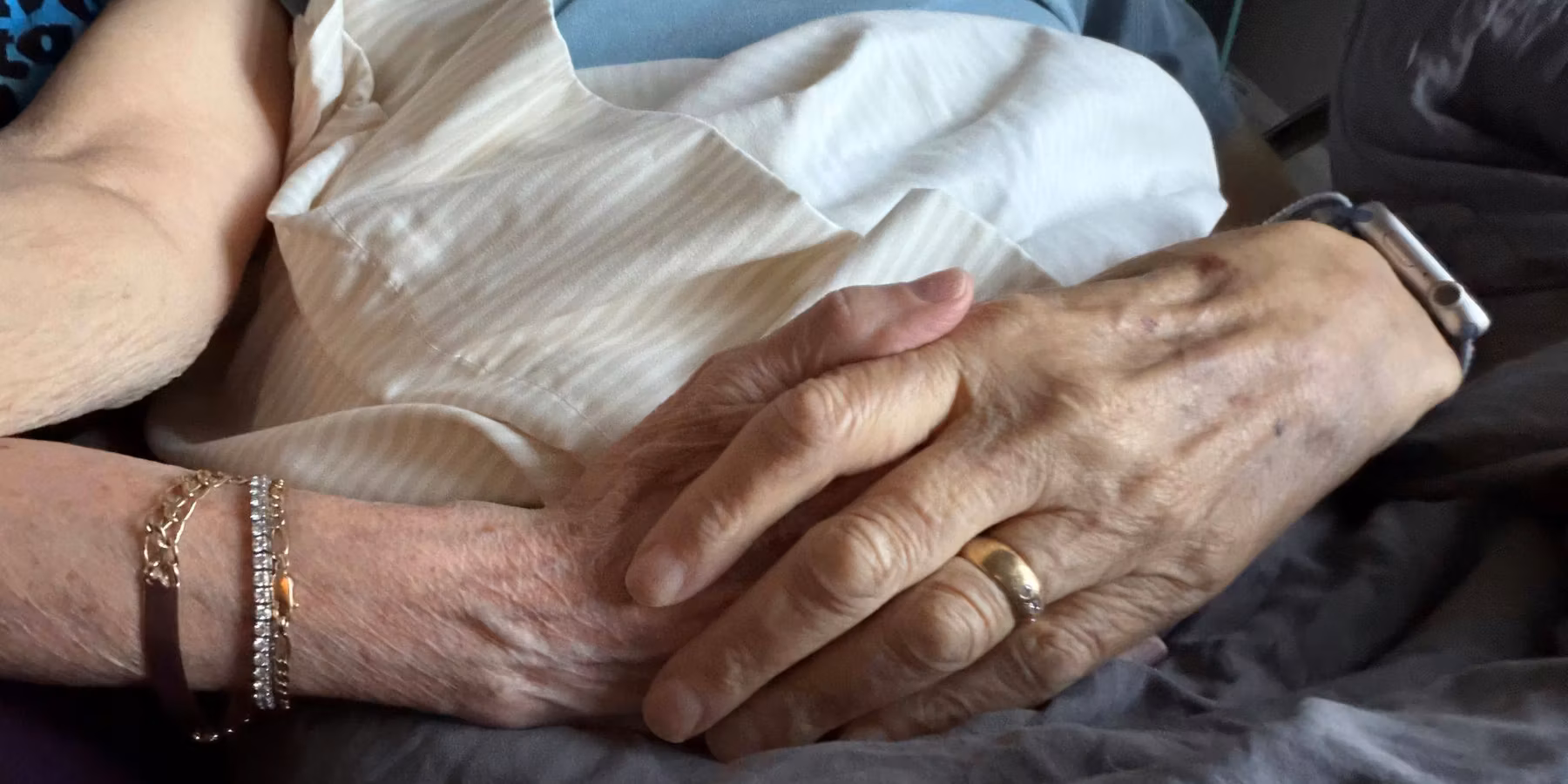 christine and her partner holding hands