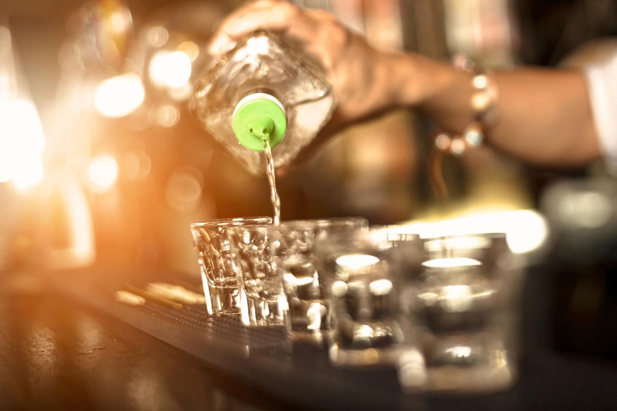 Close up of a bartender pouring alcohol