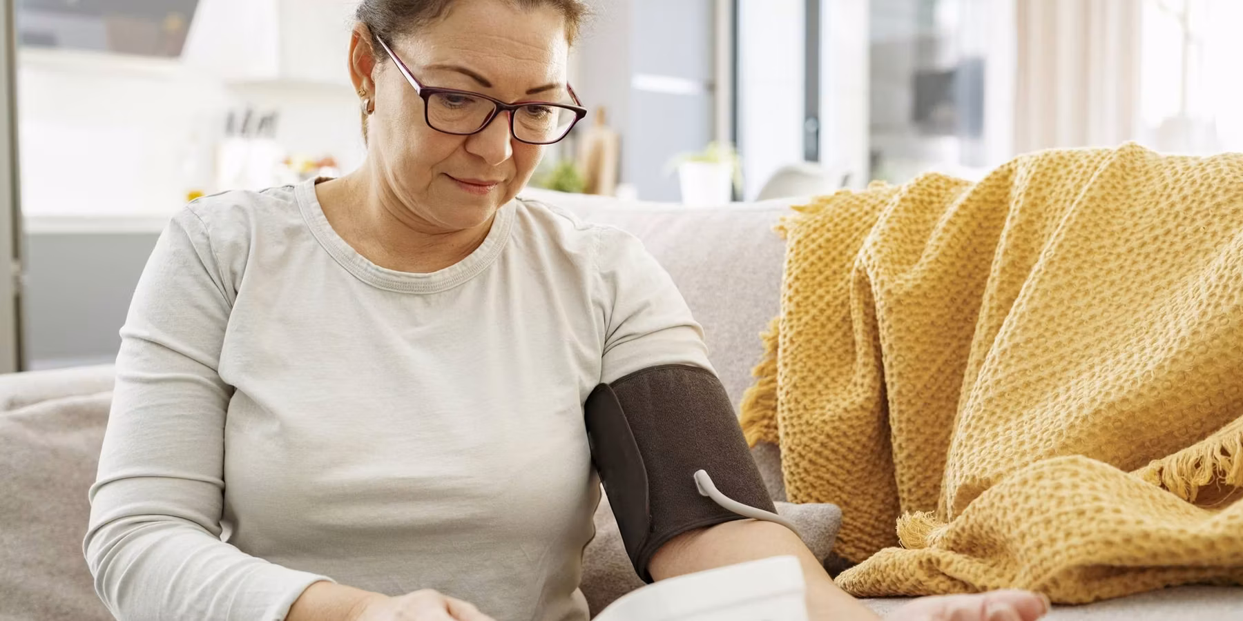 Close up of woman checking her own blood pressure