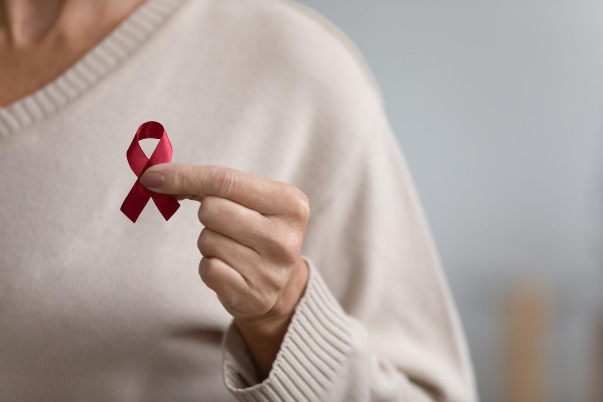 Close up of woman hold red ribbon symbol