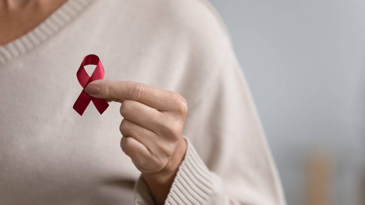 Close up of woman hold red ribbon symbol