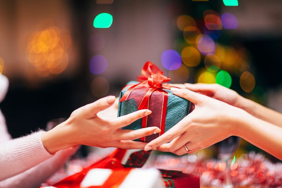 Close-up photography of two hands while giving gift.
