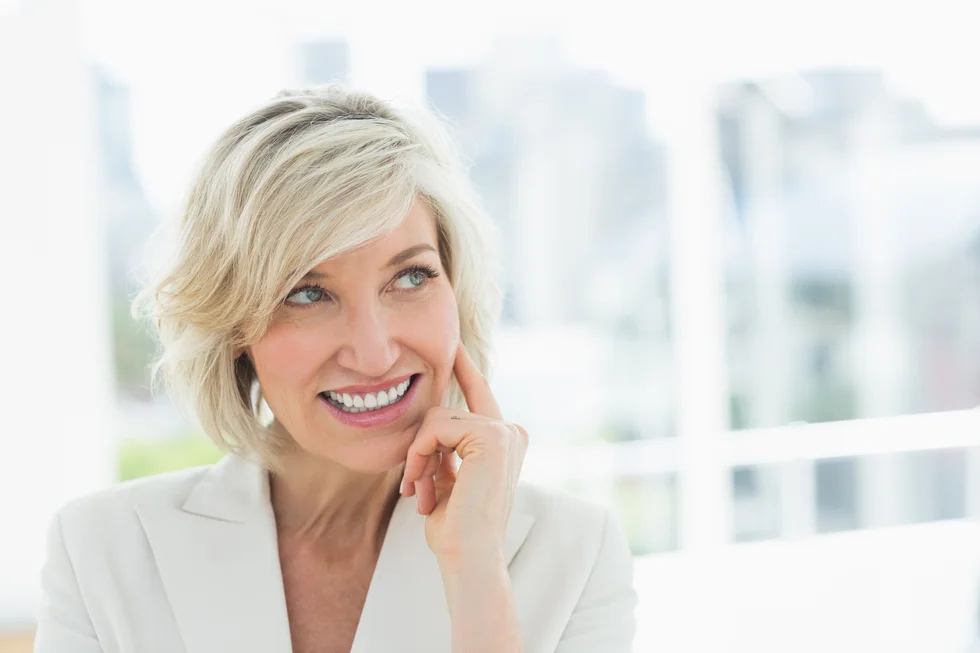 Closeup of a mature businesswoman looking away in a bright office