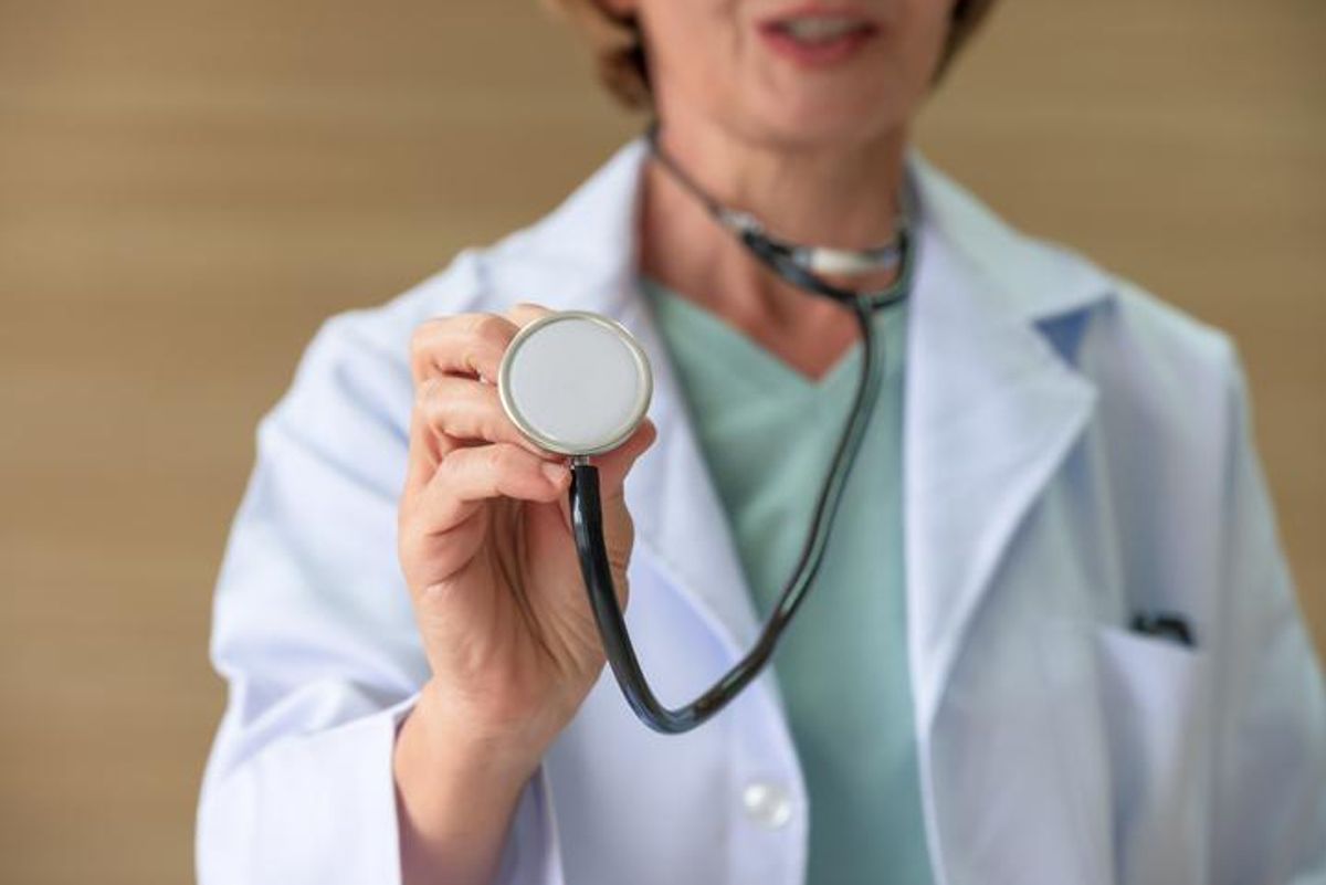 Closeup of female doctor holding stethoscope