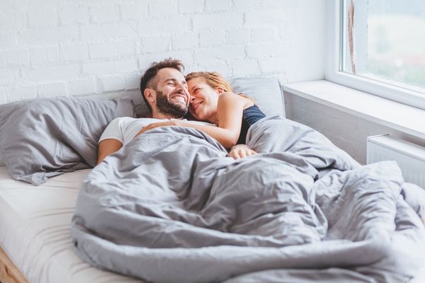 couple enjoying bedtime in the morning
