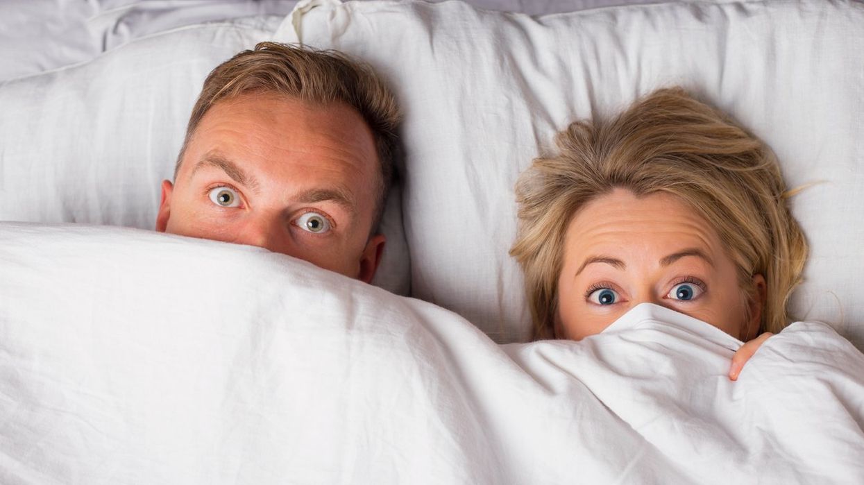 Couple hiding under sheets
