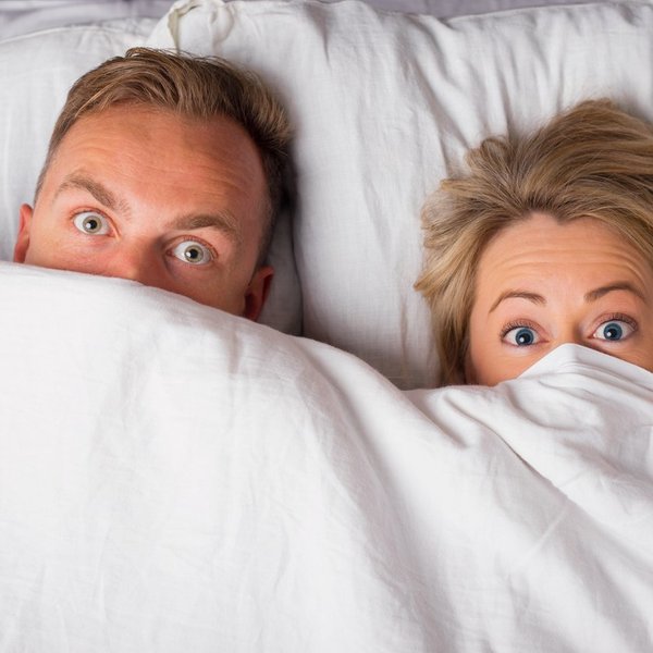 Couple hiding under sheets