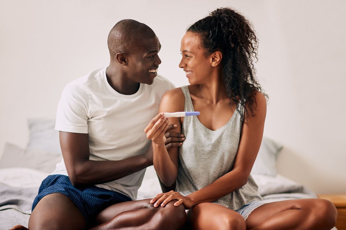 couple looking at a pregnancy test